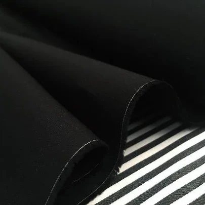 Monarch black fabric showcasing a rich, deep black color with a soft texture, ideal for various sewing and crafting projects.