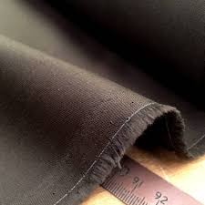 Close-up image of lightweight pocketing fabric in soft beige color, showcasing its breathable texture and fine weave ideal for garment pockets.