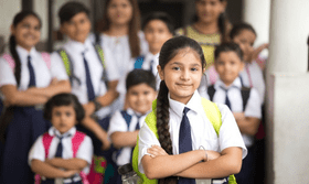 Display of school uniforms made from various fabrics, including cotton and polyester in a retail store.
