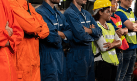 Display of various uniforms made from different fabrics, including cotton, polyester, and muslin, arranged in a retail setting.