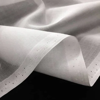 Close-up of lightweight fabric showcasing its fine weave and soft texture, ideal for draping and crafting.