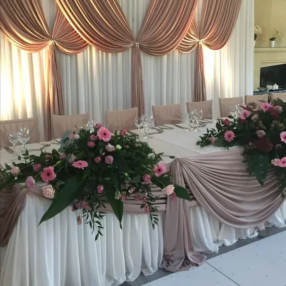 Elegant wedding decoration cloth draped beautifully at a rustic outdoor wedding venue, showcasing soft textures and neutral tones.